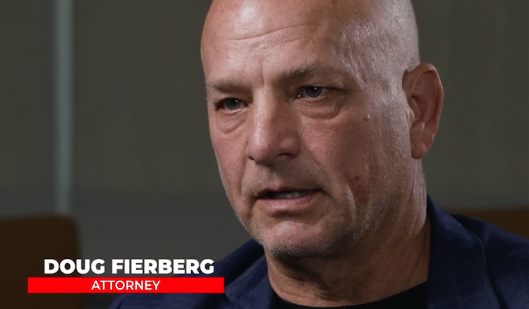 Attorney Doug Fierberg, bald and wearing a dark blazer, speaks with a focused and serious expression in a professional interview setting.