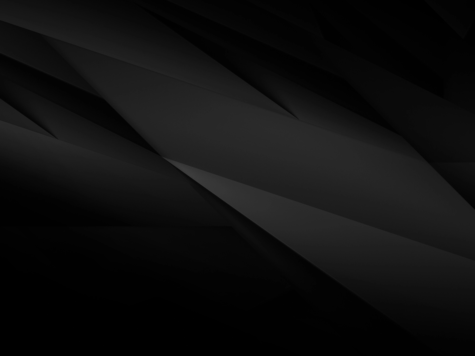 An abstract background image featuring sharp, geometric layers of black and dark gray, creating a subtle 3D diamond pattern.